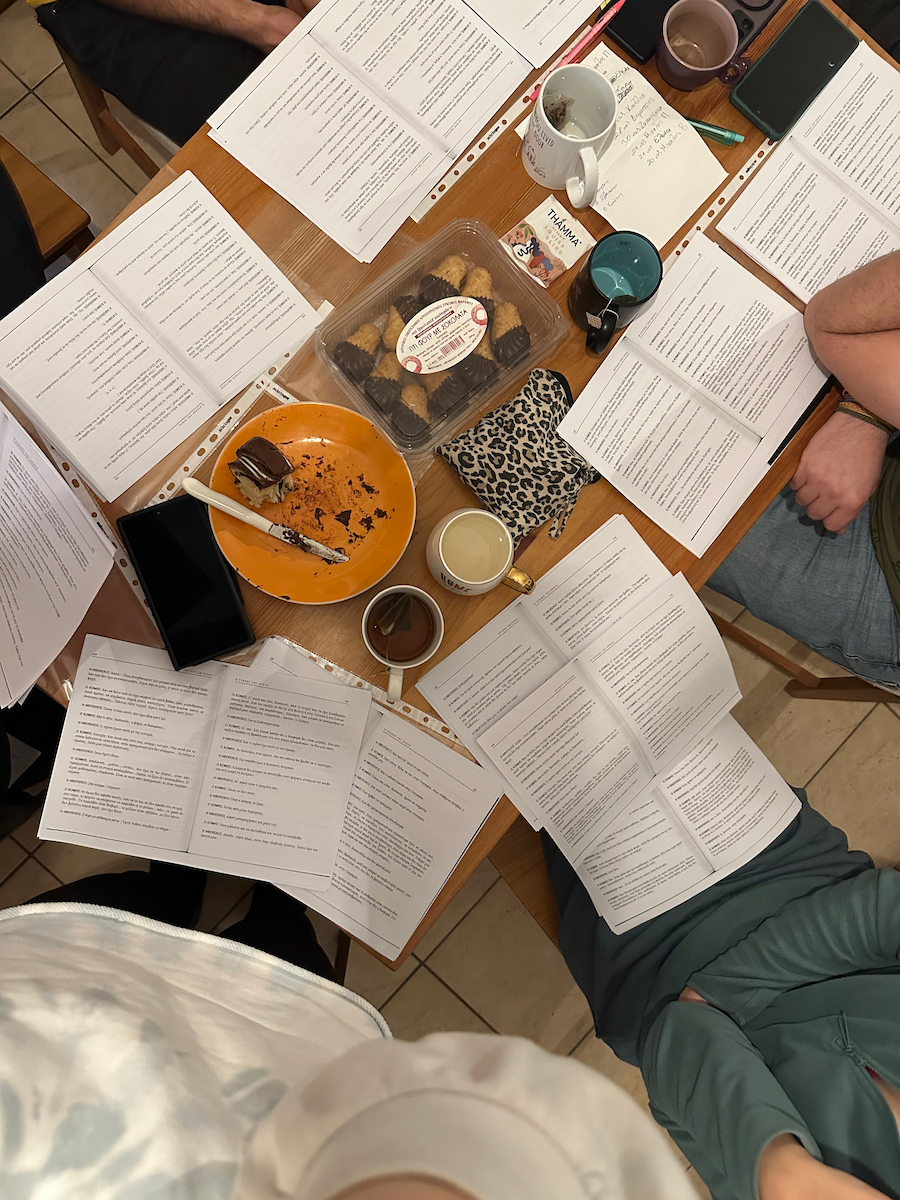 Top view of a table with various sweets and cookies and photocopies of a theatre play